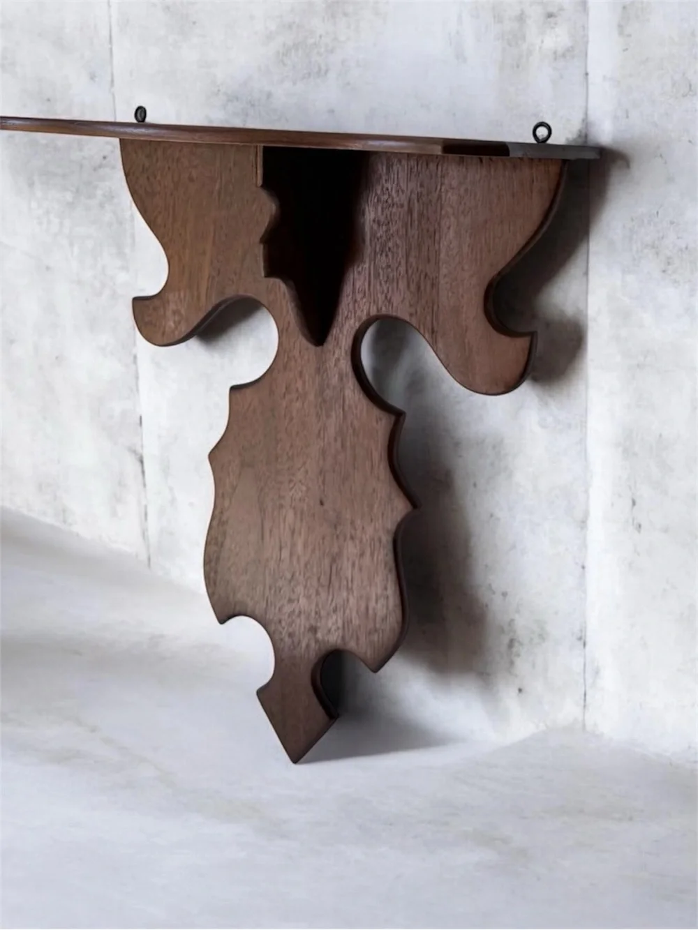 vintage wall sconce shelf made of carved wood with a dark finish